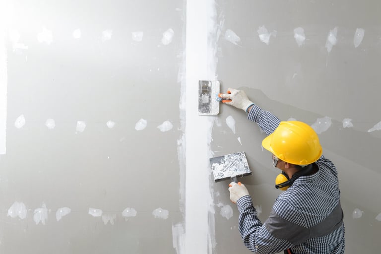 interior decoration construction furniture builtin, Plasterer in working uniform plastering the wall indoors