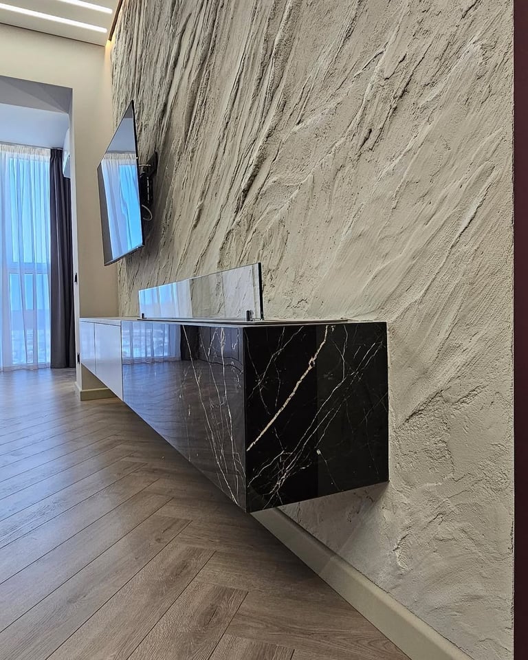 Modern reception desk with black marble counter in minimalist office lobby with textured beige wall and wooden flooring